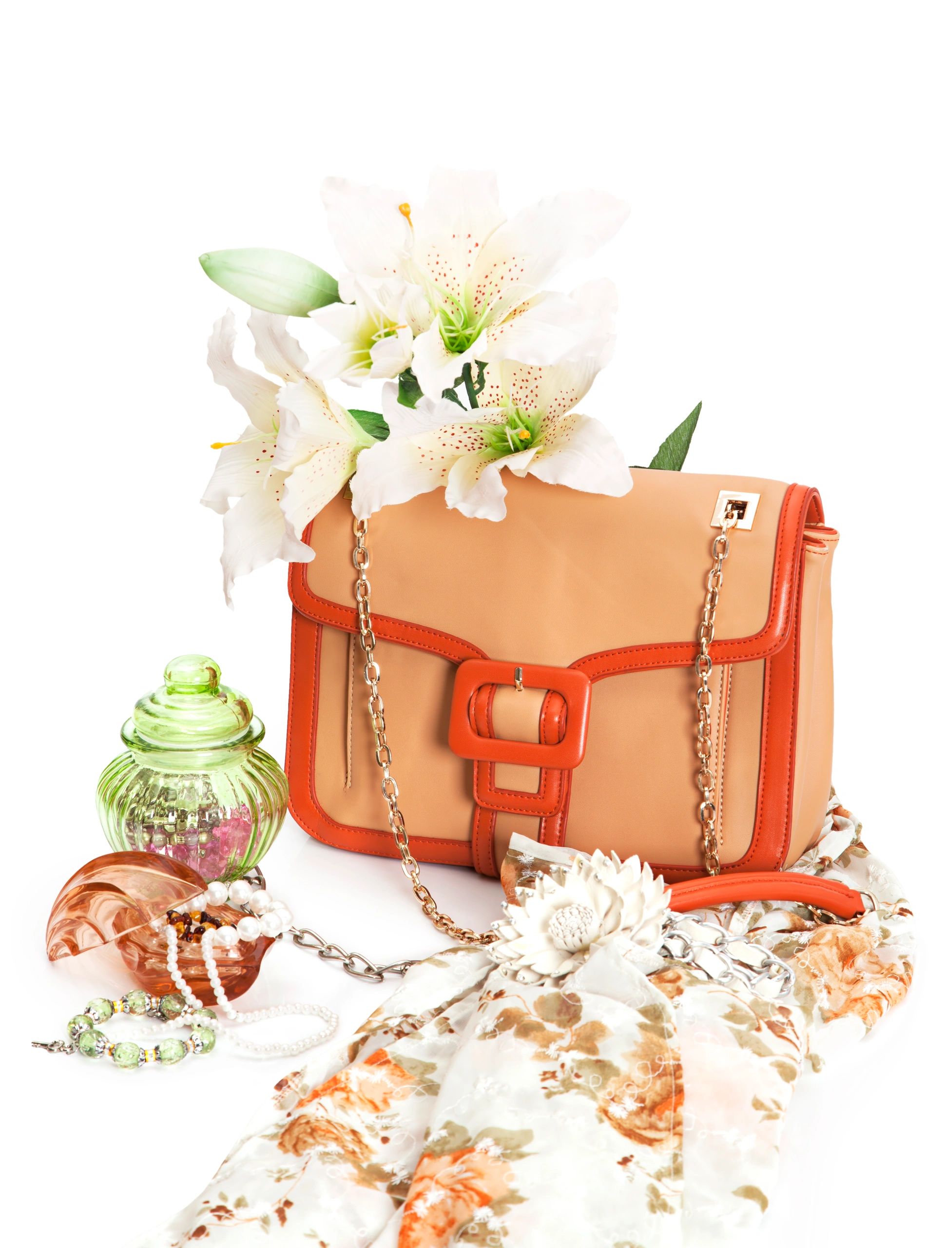 Leather handbag styled with flowers and accessories